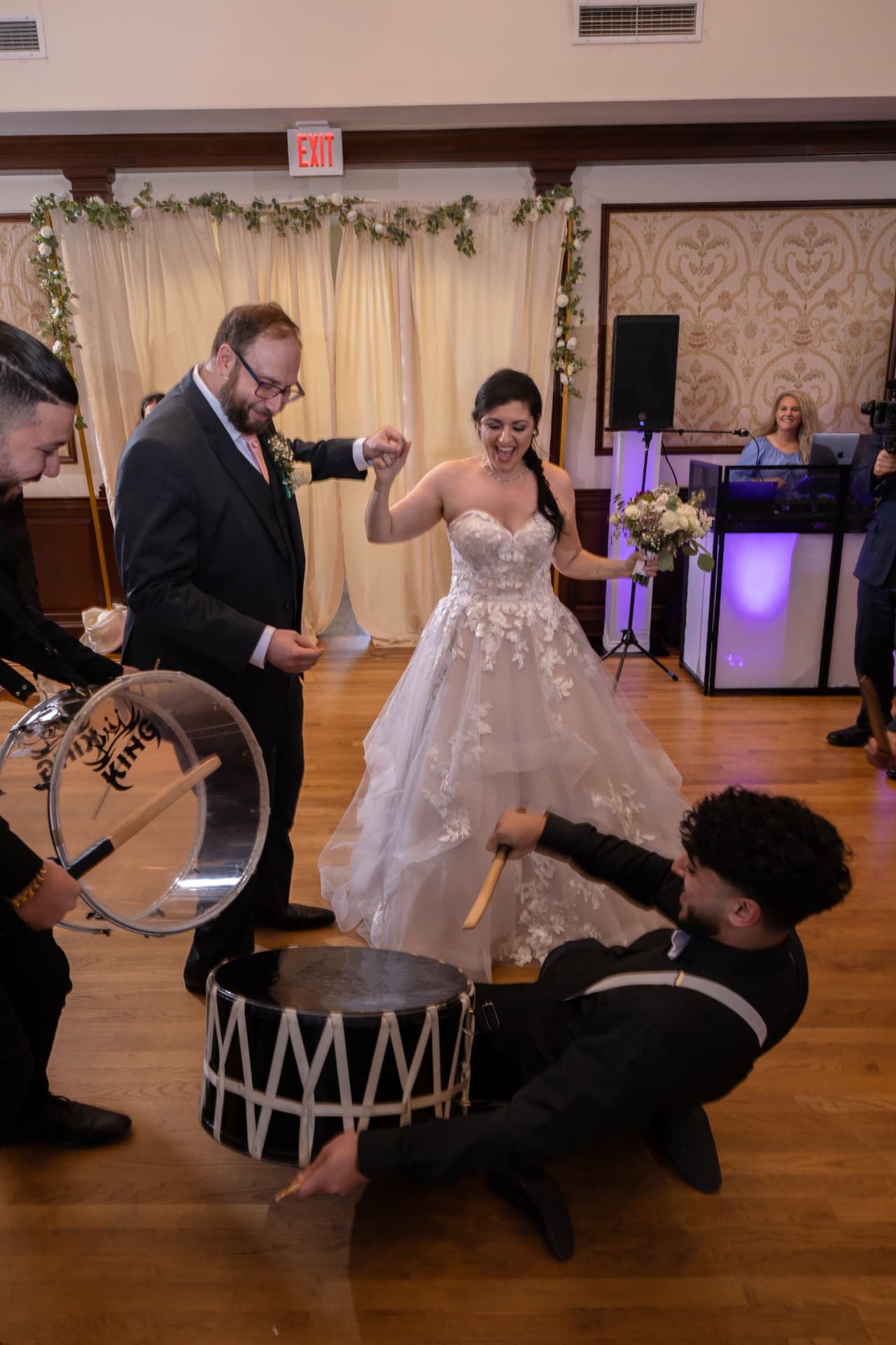 Bride and groom dancing with live drummers